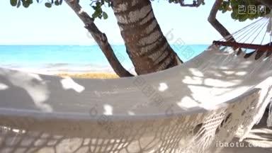加勒比海岛上阳光普照的某个沙滩上的半吊床